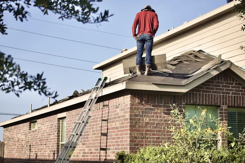 Professional roofer working on a residential roof in Roxbury Crossing